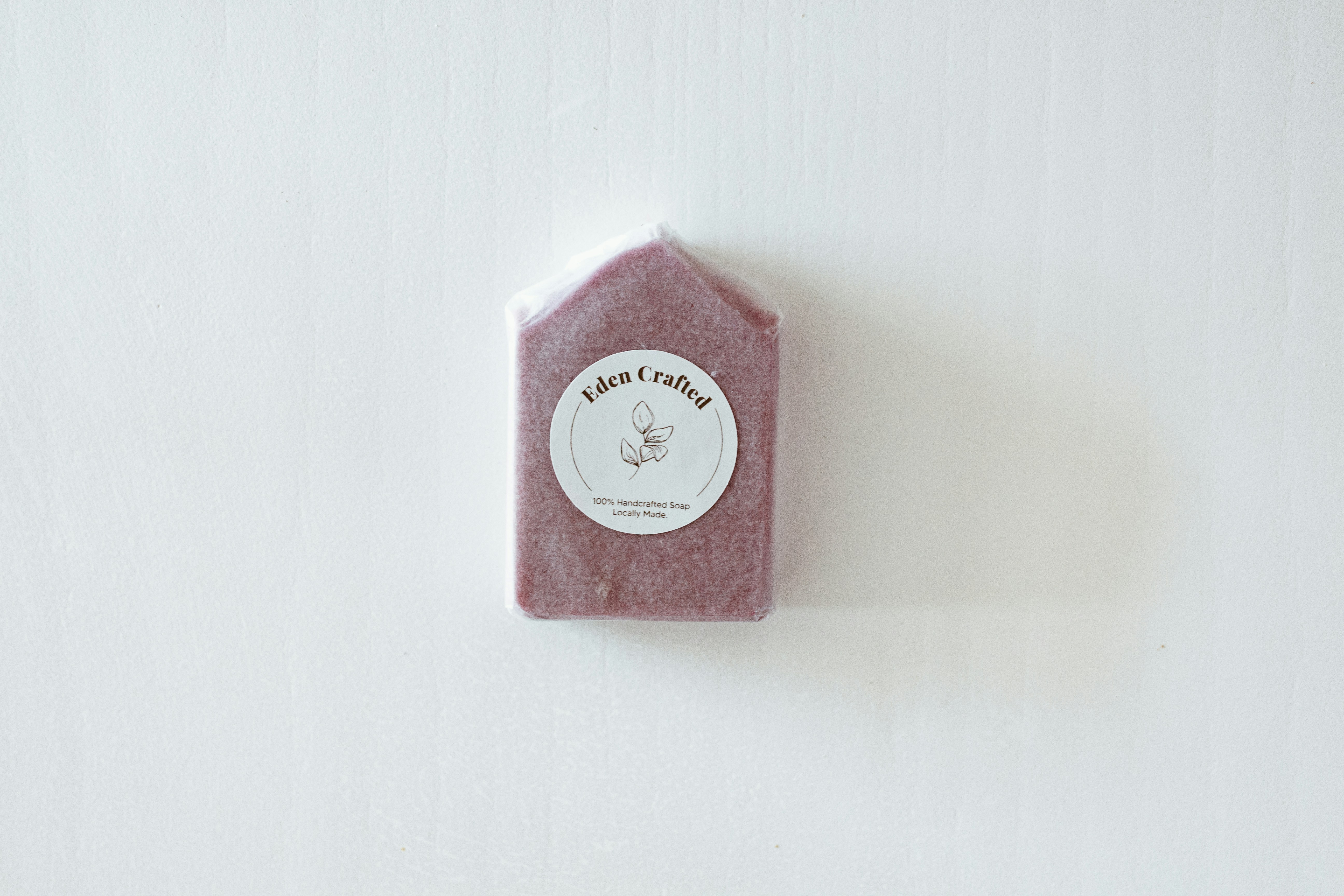 Bar of handmade soap against a white wall