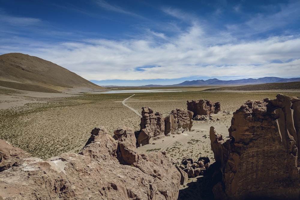 people standing on brown rock formation during daytime