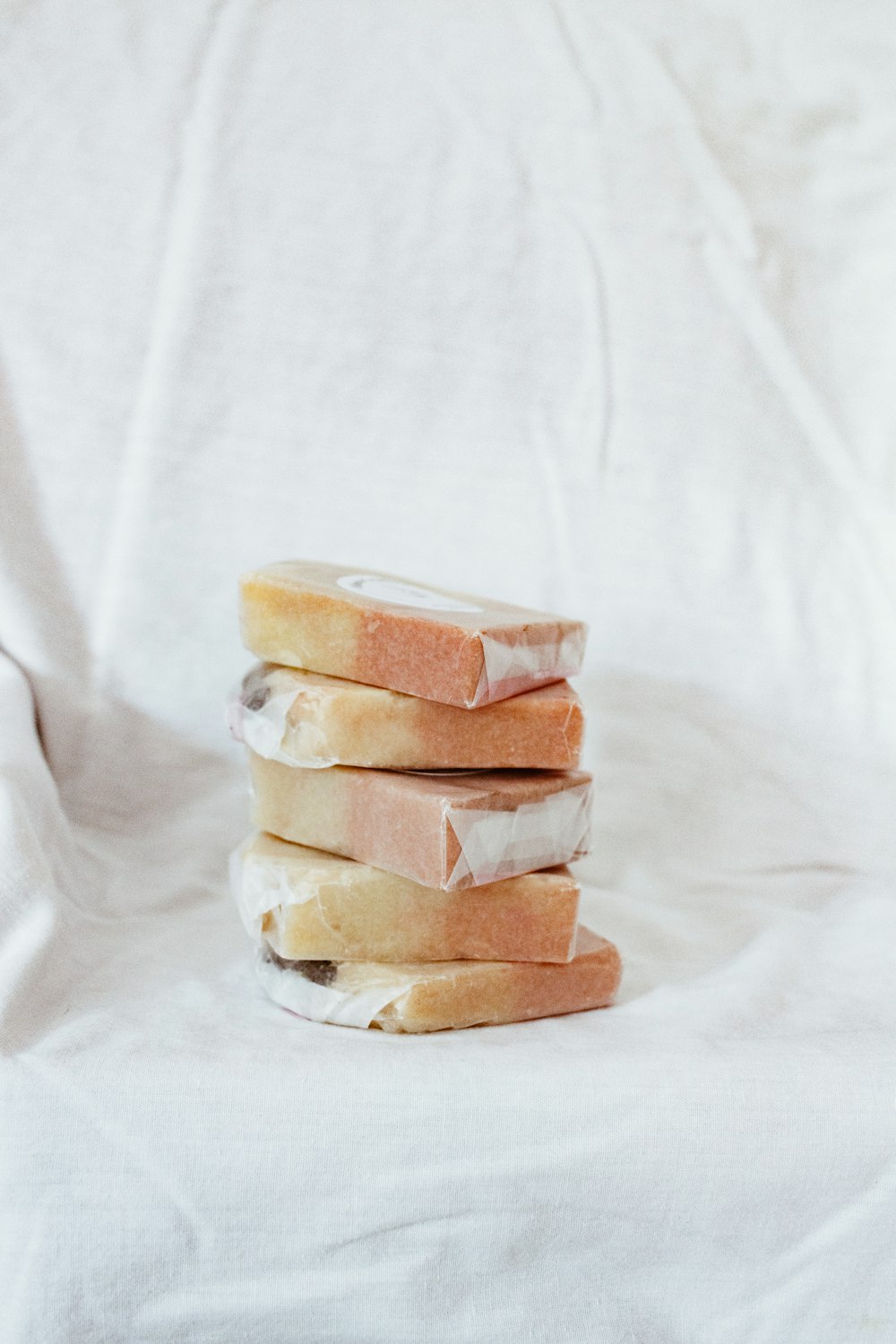 brown and white bread on white textile