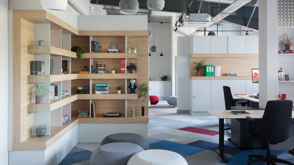 white wooden shelf with books and red ball