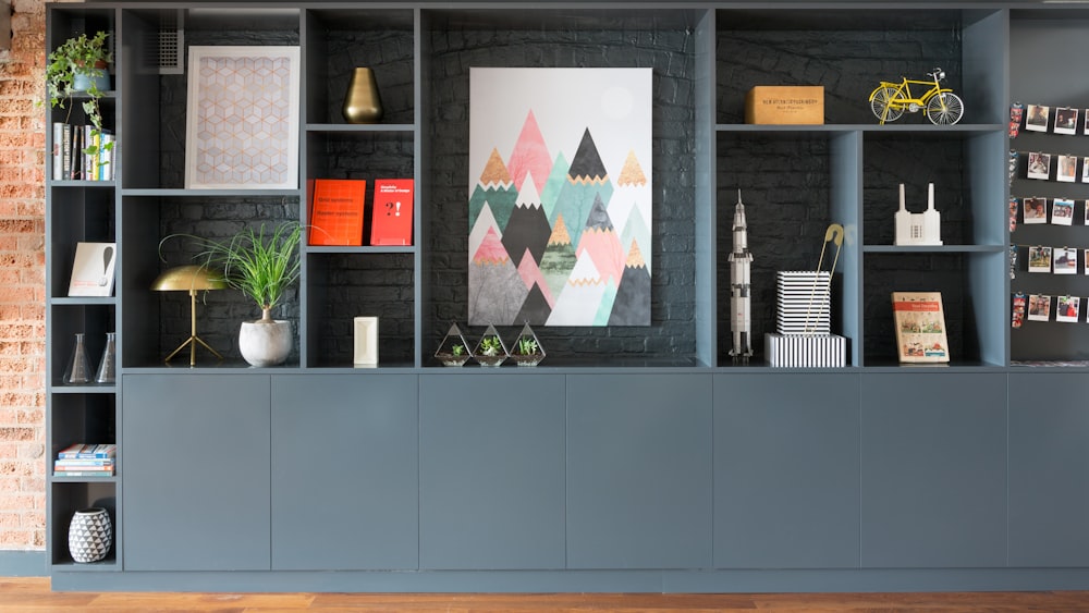 black wooden shelf with green plants