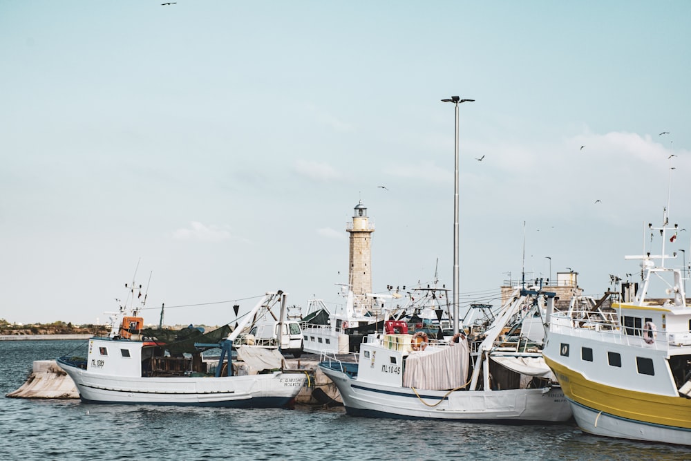 white and blue boat on sea during daytime