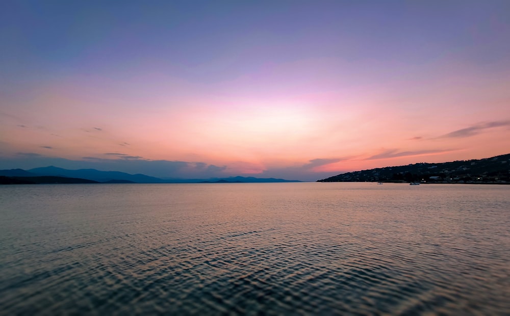 body of water during sunset