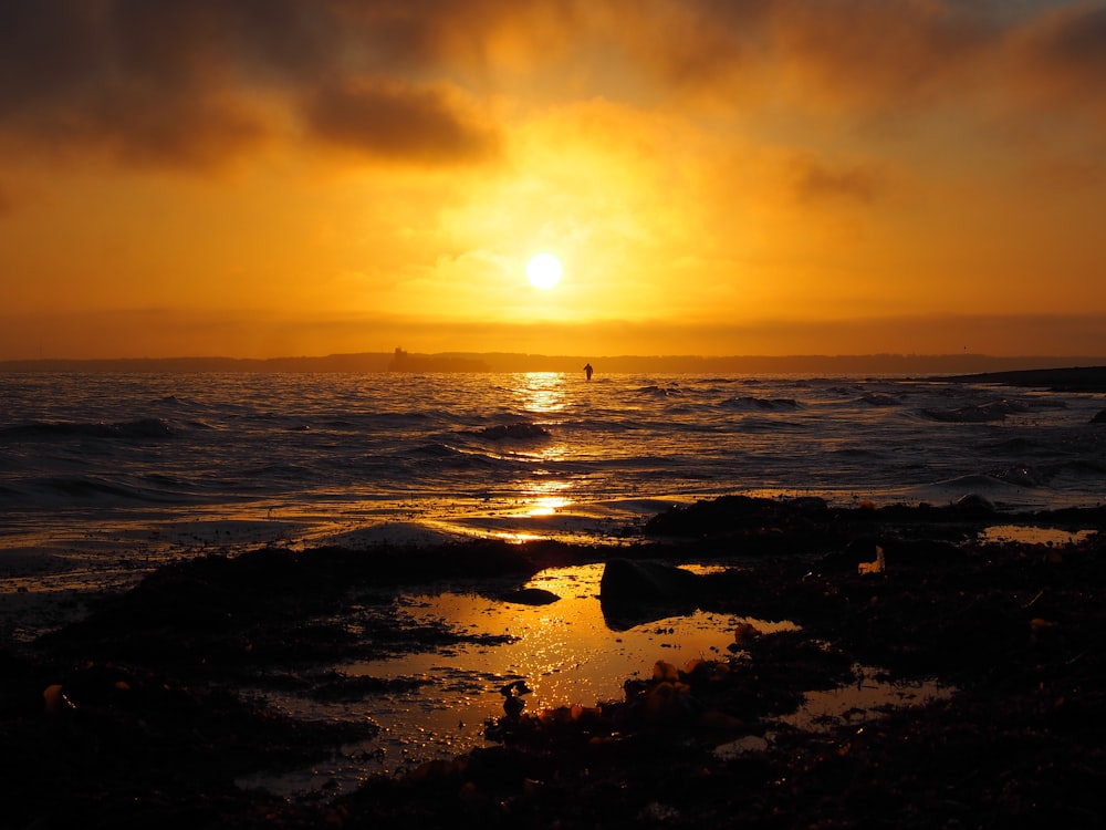 body of water during sunset