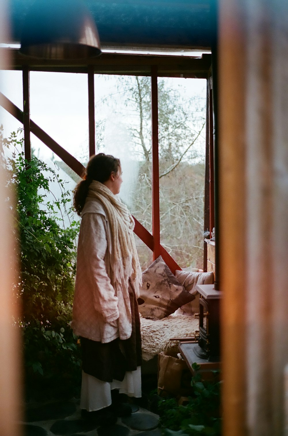 woman in white long sleeve shirt standing near window during daytime