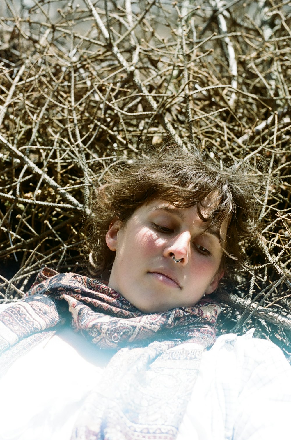 girl lying on dried grass