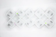 Various adapter plates laid out on a workbench, showcasing different models and sizes.