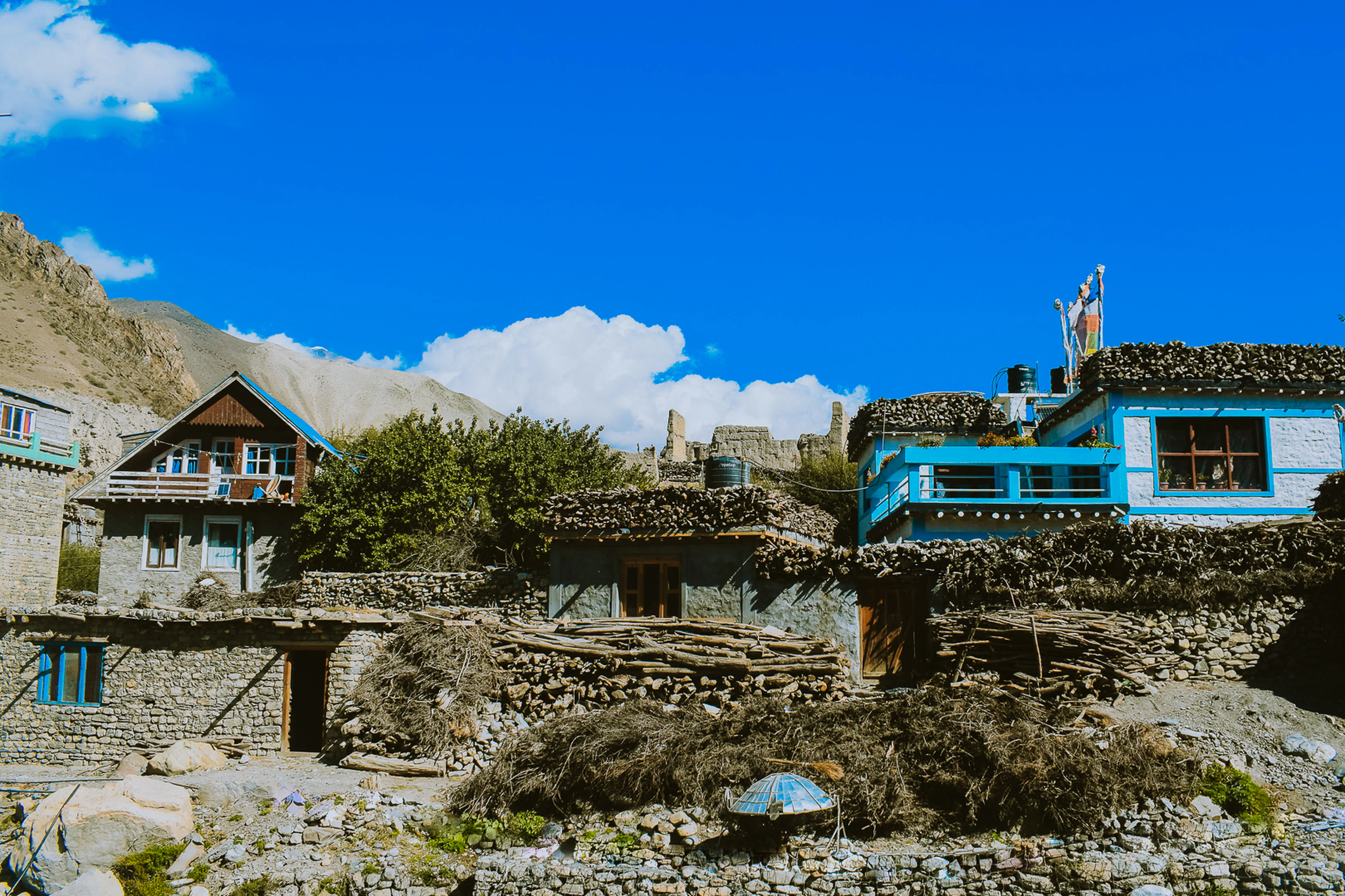 Village houses on a stone terrace under a blue sky