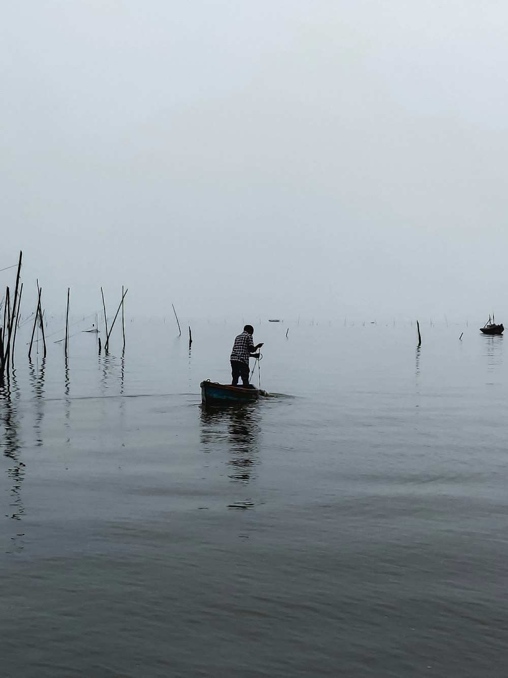 man in black shirt sitting on boat on sea during daytime