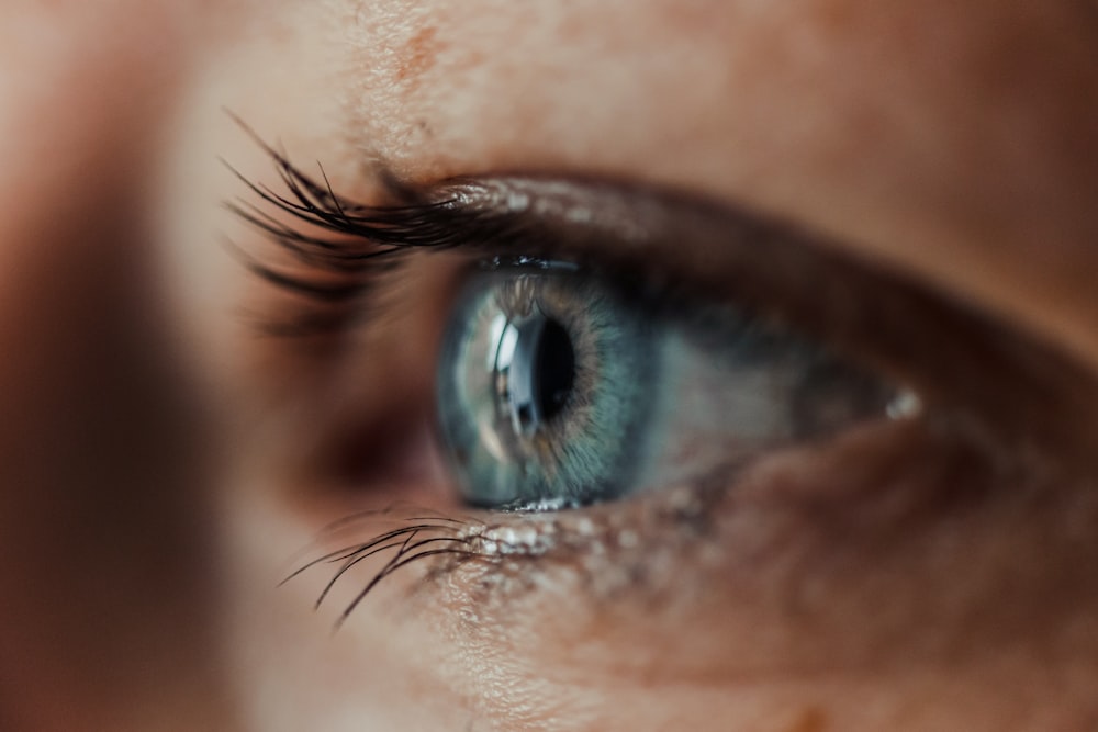 persons eye in close up photography