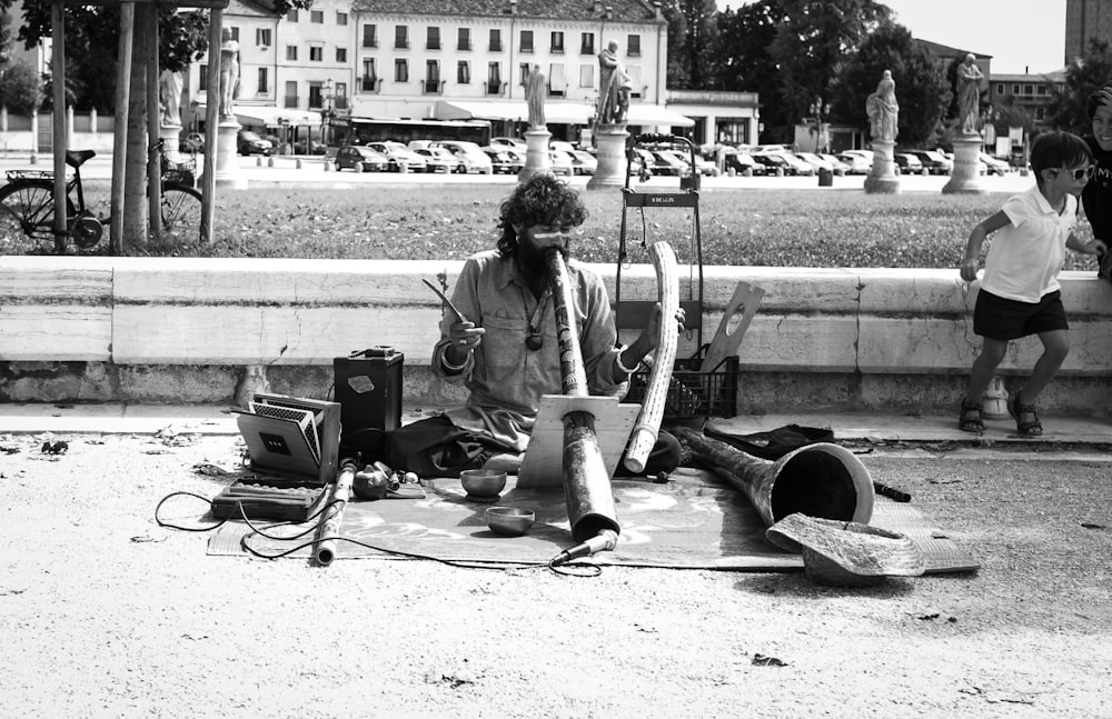 grayscale photo of man playing guitar