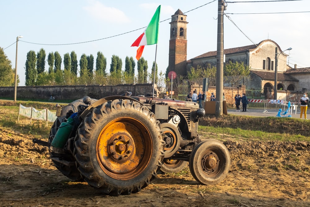 green and yellow tractor on green grass field during daytime