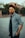 man in black and white checkered button up shirt wearing black sunglasses standing on gray concrete