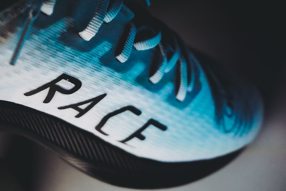 blue and white adidas athletic shoe