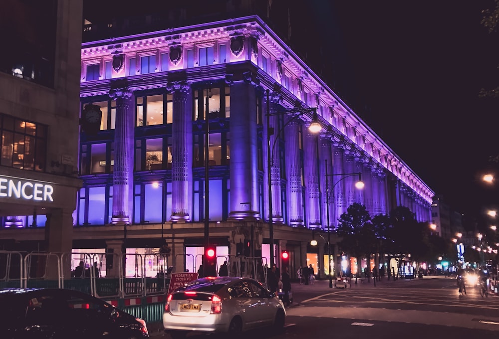 cars parked in front of building during night time