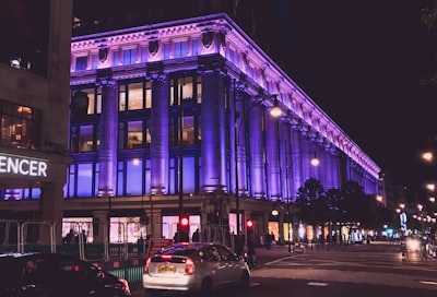 cars parked in front of building during night time