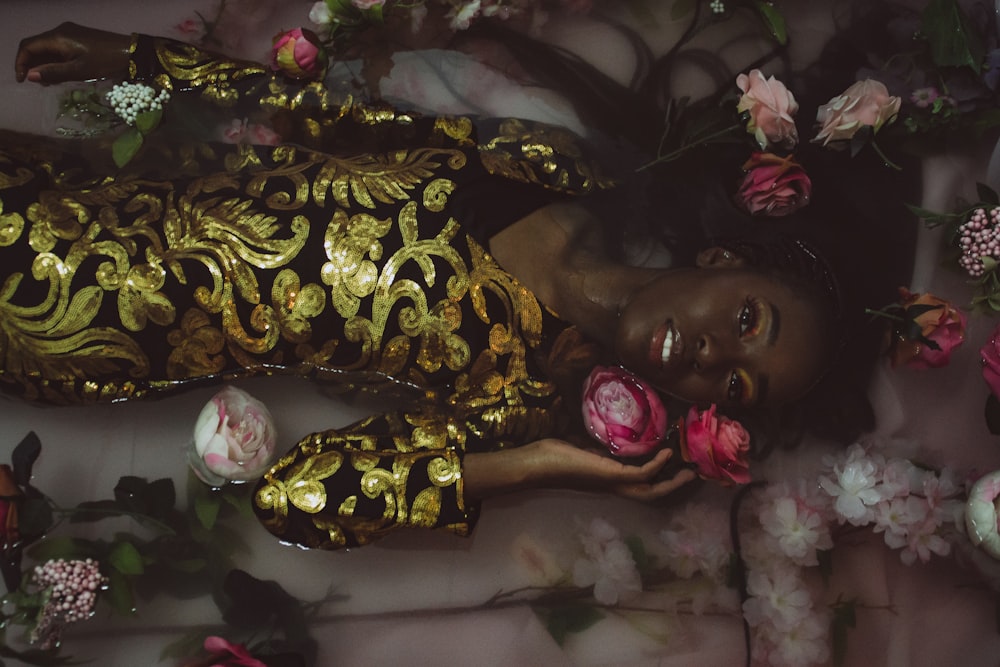 woman in black and yellow floral dress beside woman in white shirt