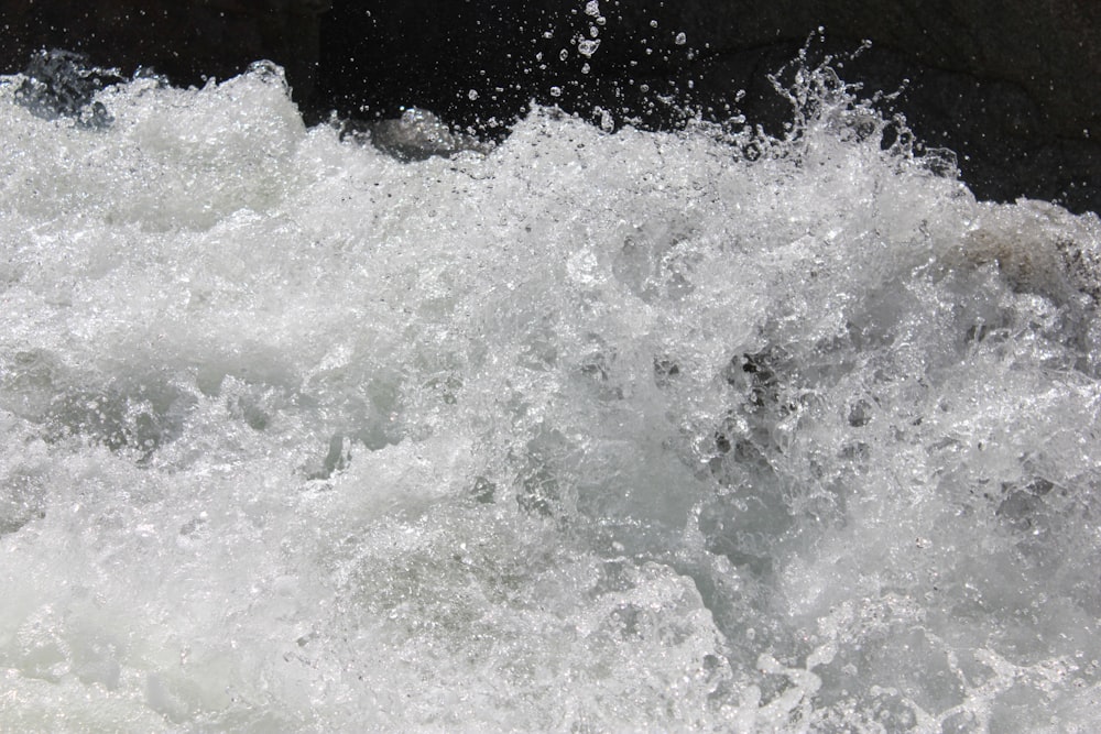 water waves on brown wooden fence