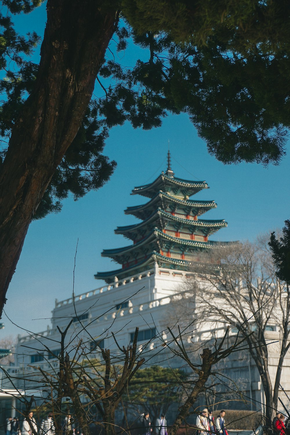 white and black temple near bare trees during daytime