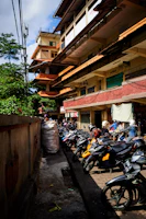 Motorcycles neatly parked in designated spaces with a backdrop of urban buildings.