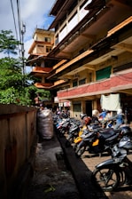 motorcycle parked beside wooden fence during daytime