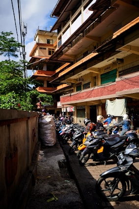 motorcycle parked beside wooden fence during daytime