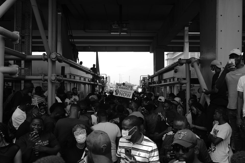 grayscale photo of people in a street