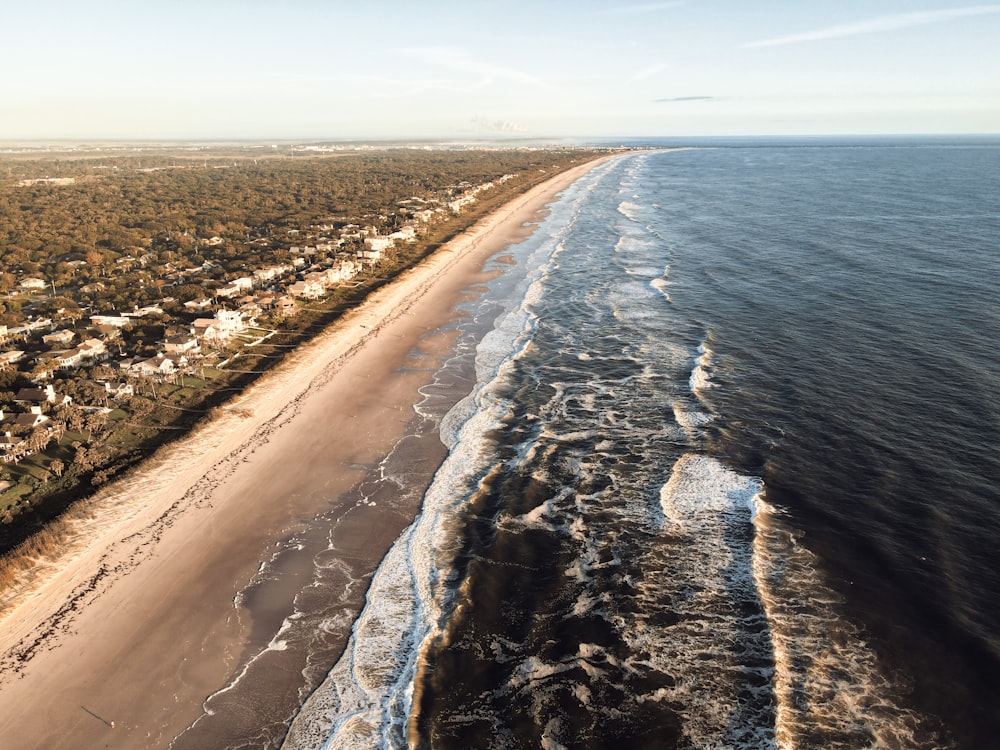 brown sand near body of water during daytime