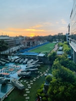 A wide view of a landscaped front yard featuring manicured lawns and decorative rocks.