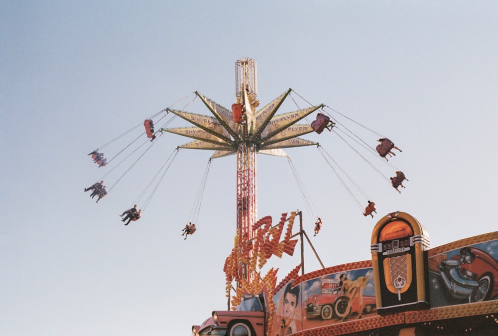 yellow and red ferris wheel under blue sky during daytime