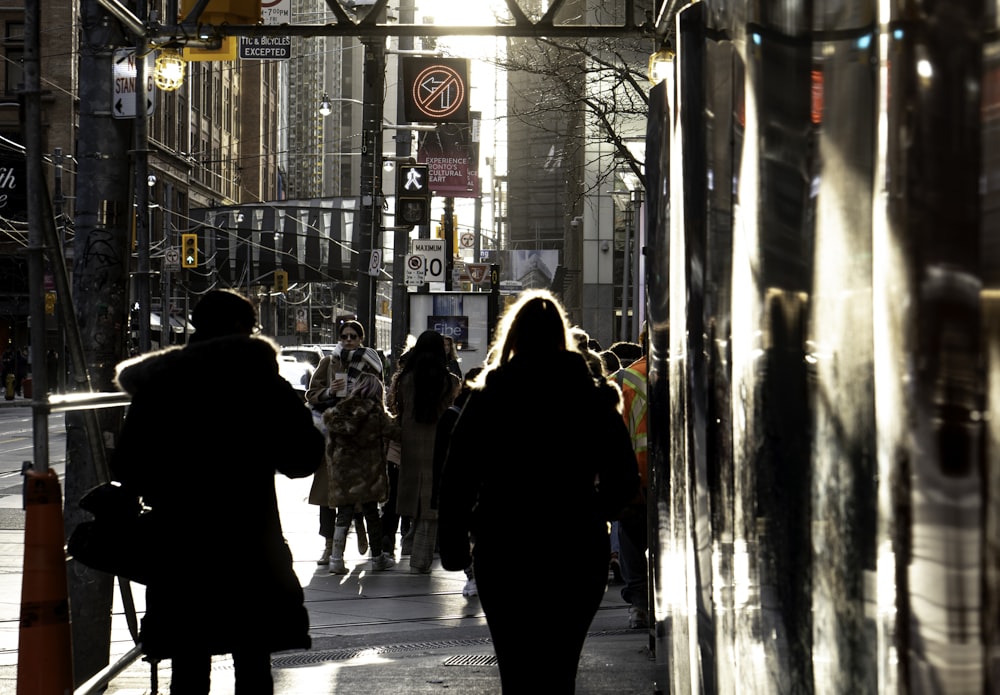 people walking on sidewalk during night time