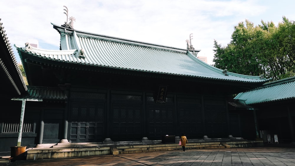 gray wooden house near green trees during daytime