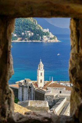 Bell tower and terracotta rooftops of Dubrovnik old town above the Adriatic