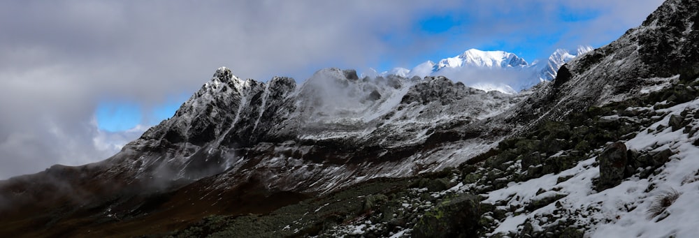 snow covered mountain under cloudy sky during daytime