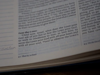 A close-up view of a page from a Bible showing a passage with some text highlighted or emphasized. The text discusses themes of devotion and obedience. The page appears slightly worn with a handwritten note in the margin.