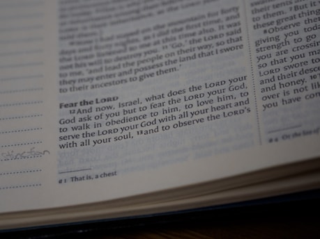 A close-up view of a page from a Bible showing a passage with some text highlighted or emphasized. The text discusses themes of devotion and obedience. The page appears slightly worn with a handwritten note in the margin.