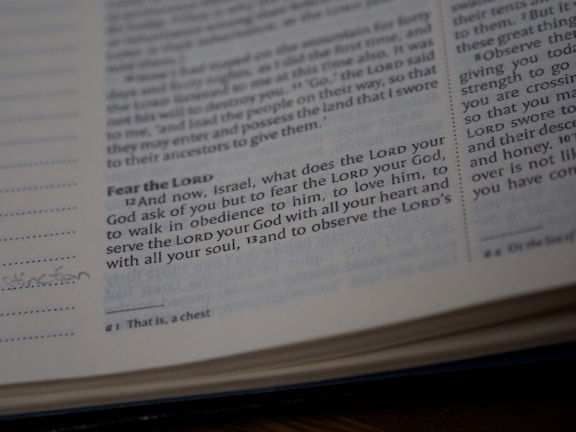 A close-up view of a page from a Bible showing a passage with some text highlighted or emphasized. The text discusses themes of devotion and obedience. The page appears slightly worn with a handwritten note in the margin.