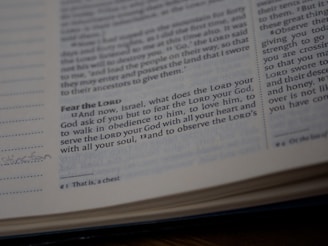 A close-up view of a page from a Bible showing a passage with some text highlighted or emphasized. The text discusses themes of devotion and obedience. The page appears slightly worn with a handwritten note in the margin.