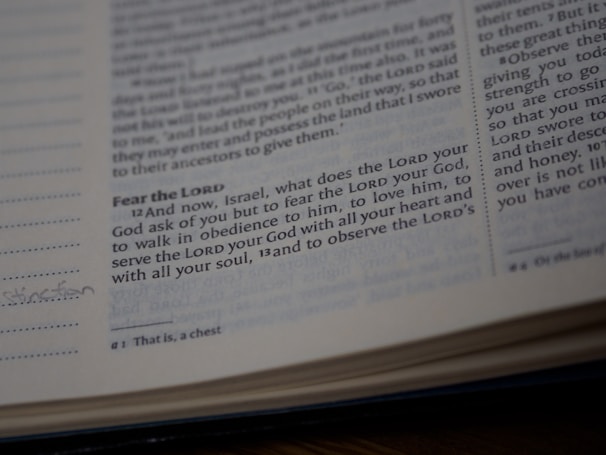 A close-up view of a page from a Bible showing a passage with some text highlighted or emphasized. The text discusses themes of devotion and obedience. The page appears slightly worn with a handwritten note in the margin.