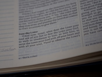 A close-up view of a page from a Bible showing a passage with some text highlighted or emphasized. The text discusses themes of devotion and obedience. The page appears slightly worn with a handwritten note in the margin.