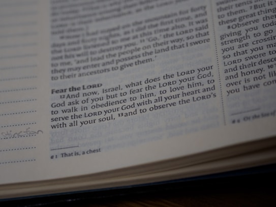 A close-up view of a page from a Bible showing a passage with some text highlighted or emphasized. The text discusses themes of devotion and obedience. The page appears slightly worn with a handwritten note in the margin.