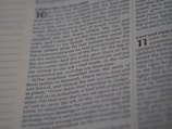 An open Bible displaying text from Deuteronomy chapter 10 to 11. The focus is on the text narrating the events related to the tablets with the Ten Commandments. The page number and chapter numbers are also visible.