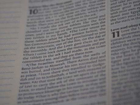 An open Bible displaying text from Deuteronomy chapter 10 to 11. The focus is on the text narrating the events related to the tablets with the Ten Commandments. The page number and chapter numbers are also visible.