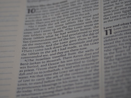An open Bible displaying text from Deuteronomy chapter 10 to 11. The focus is on the text narrating the events related to the tablets with the Ten Commandments. The page number and chapter numbers are also visible.
