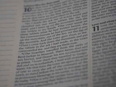 An open Bible displaying text from Deuteronomy chapter 10 to 11. The focus is on the text narrating the events related to the tablets with the Ten Commandments. The page number and chapter numbers are also visible.