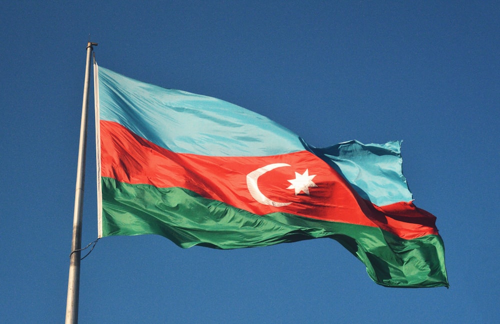 red and white flag under blue sky during daytime