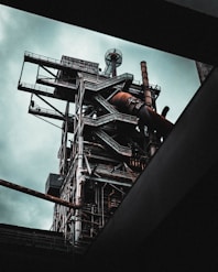 man in black jacket and pants standing on top of building
