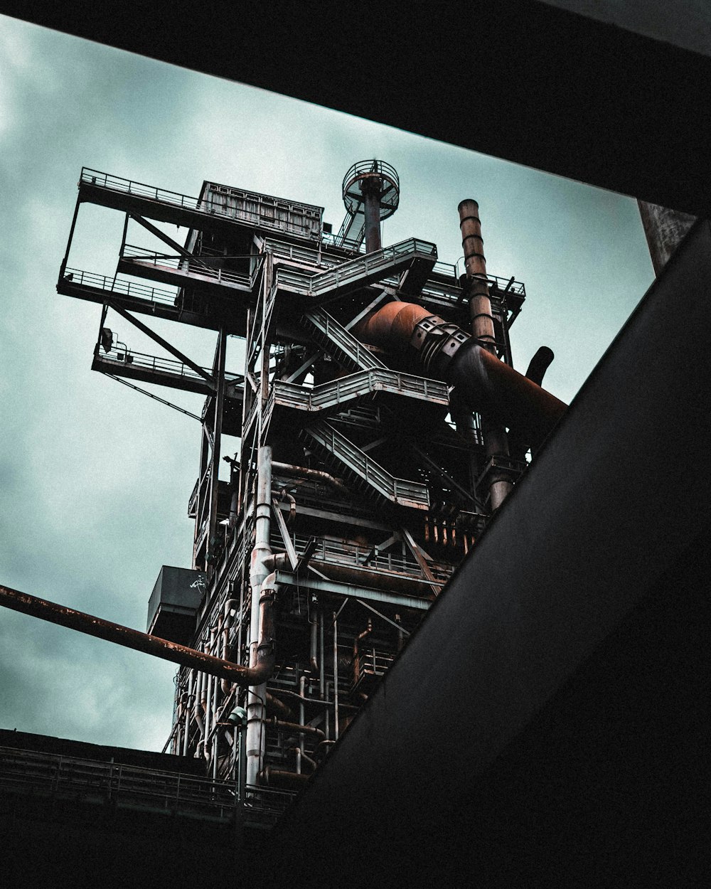 man in black jacket and pants standing on top of building