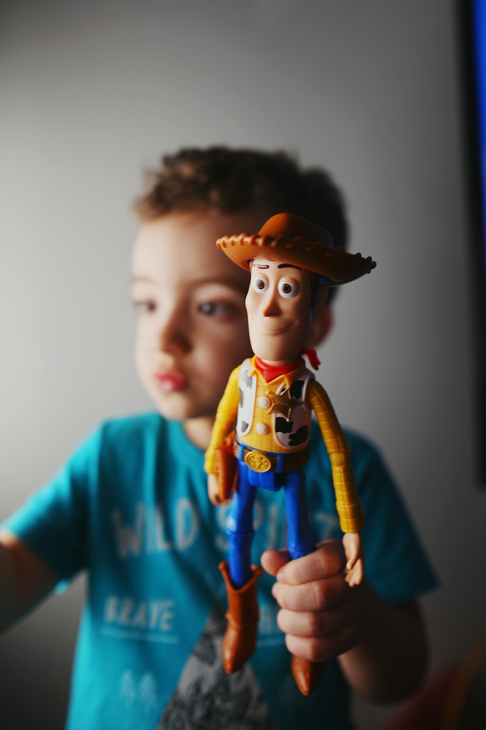 boy in blue crew neck t-shirt wearing brown hat