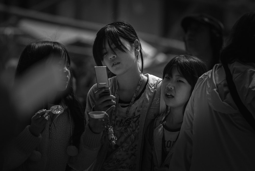 Photo en niveaux de gris d’une femme et d’une fille tenant un verre à boire